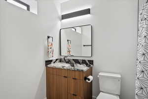 Full bathroom featuring toilet and vanity