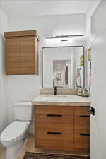 Bathroom featuring vanity, tile patterned flooring, and toilet