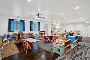 Game room with recessed lighting, concrete floors, a ceiling fan, and a wealth of natural light