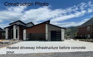 View of front of property featuring view of heated driveway installation