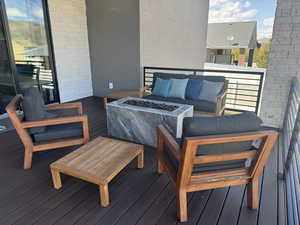 Balcony featuring an outdoor living space with a fire pit