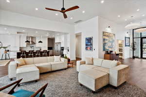 Living area featuring dark wood finished floors, ceiling fan, visible vents, and recessed lighting