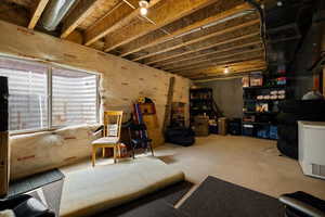 Basement featuring refrigerator