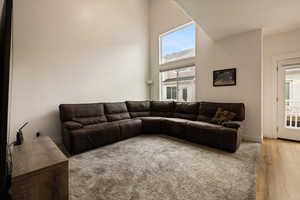 Living area with a high ceiling and wood finished floors