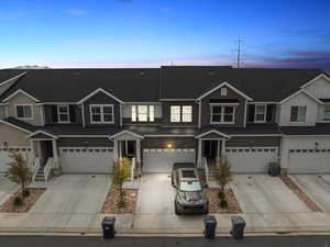 View of property with an attached garage, driveway, and board and batten siding