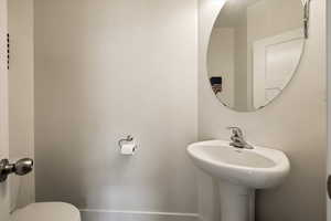 Half bath with a sink and toilet