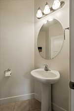 Bathroom featuring tile patterned floors and baseboards