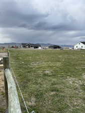 View of yard with a mountain view and a rural view