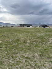 View of yard with a rural view and a mountain view