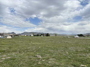 View of yard with a mountain view and a rural view