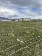 View of yard featuring a rural view and a mountain view
