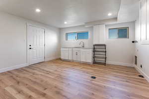 Bar featuring recessed lighting, a textured ceiling, visible vents, and light wood-type flooring
