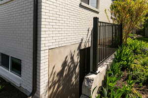 View of property exterior with brick siding