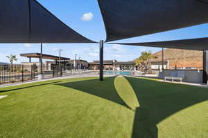View of yard with fence and a community pool