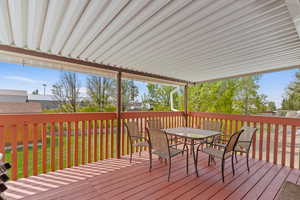Wooden terrace with a yard and outdoor dining area