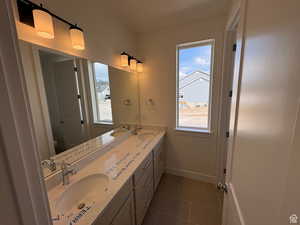 Bathroom featuring a wealth of natural light, a sink, and toilet
