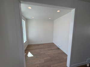 Empty room with visible vents, wood finished floors, and recessed lighting
