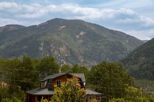 Property view of mountains featuring a wooded view