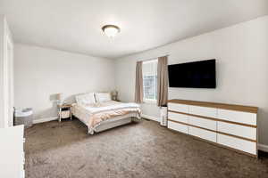 Carpeted bedroom featuring baseboards