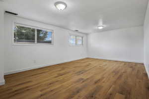 Empty room with baseboards and wood finished floors