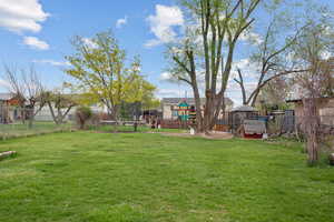 View of yard with fence and a playground