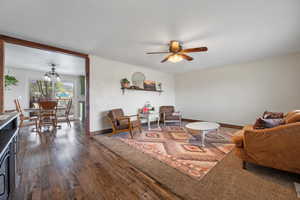 Living room featuring ceiling fan, baseboards, and wood finished floors