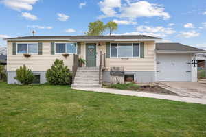 Ranch-style home featuring concrete driveway, a front lawn, and a garage