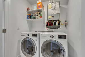 Washroom with water heater, washer and dryer, and laundry area