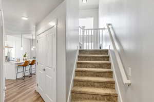 Stairway featuring wood finished floors and a textured ceiling