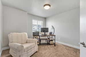 Home office featuring carpet flooring and baseboards