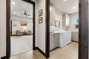Laundry area with separate washer and dryer, ceiling fan, cabinet space, baseboards, and recessed lighting