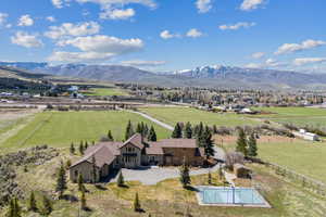 Birds eye view of property with a rural view and a mountain view