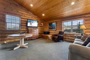 Interior space featuring recessed lighting, vaulted ceiling, and rustic walls