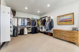 Spacious closet with light colored carpet