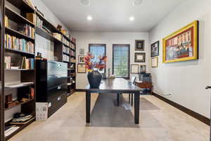 Office area with baseboards, recessed lighting, and light colored carpet