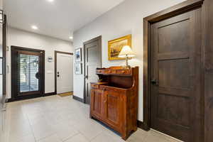 Foyer entrance with baseboards and recessed lighting