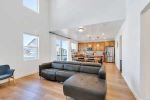 Living room with recessed lighting, light wood-type flooring, and baseboards