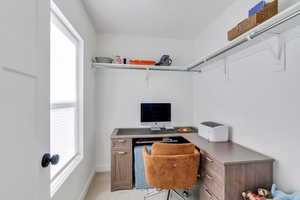 Office space with light carpet and baseboards