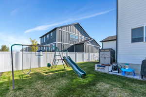 View of jungle gym featuring a fenced backyard and a lawn