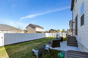 View of yard with a fenced backyard, a residential view, and a patio