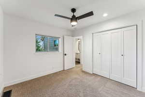 Unfurnished bedroom featuring visible vents, light carpet, a closet, baseboards, and ceiling fan