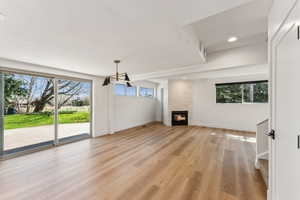 Unfurnished living room with recessed lighting, baseboards, light wood-style floors, and a fireplace