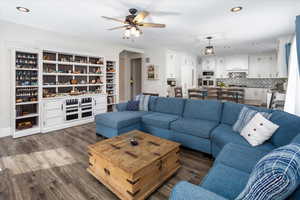 Living room featuring ceiling fan, dark wood-type flooring, and recessed lighting