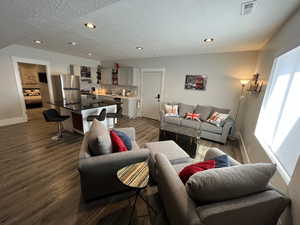ADU Living area featuring recessed lighting, dark wood-type flooring