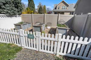 View of yard with fence private yard and garden boxes