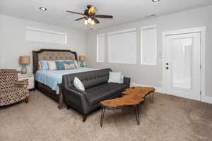 Primary Bedroom with light carpet, a ceiling fan, and recessed lighting