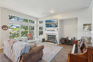 Living area with wood finished floors and a fireplace