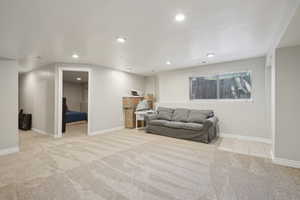 Living room with recessed lighting, carpet flooring, and baseboards