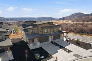 View of front facade featuring an attached garage, driveway, and a mountain view
