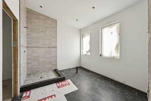 Full bathroom featuring a shower stall